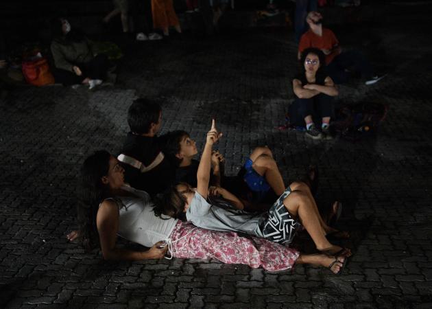 People observe the Moon from a park in Rio de Janeiro, Brazil, on May 16, 2022.