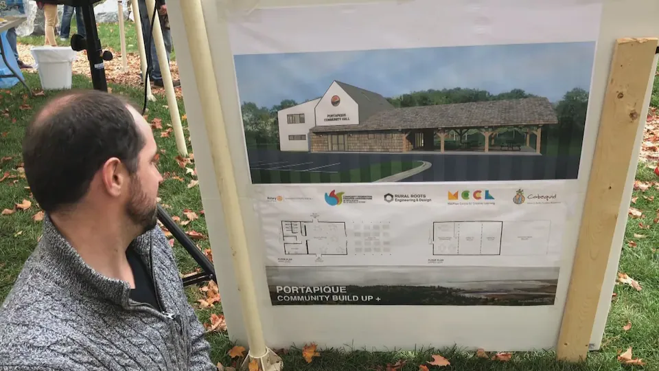 A resident of Portapique consults the plans for the future community center.