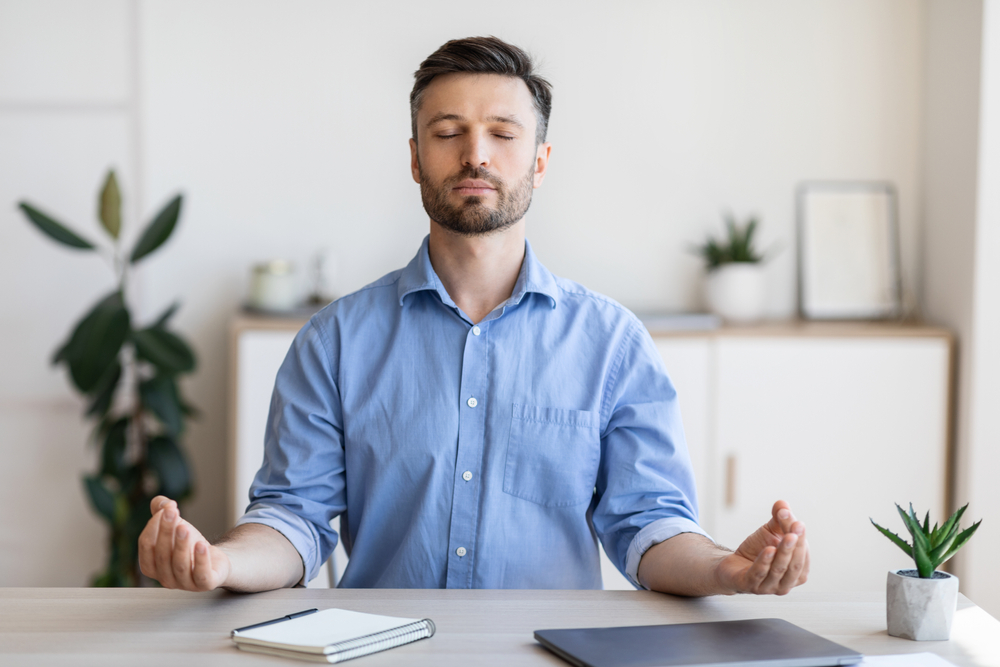 meditation-antistress man in shirt meditates in front of his face
