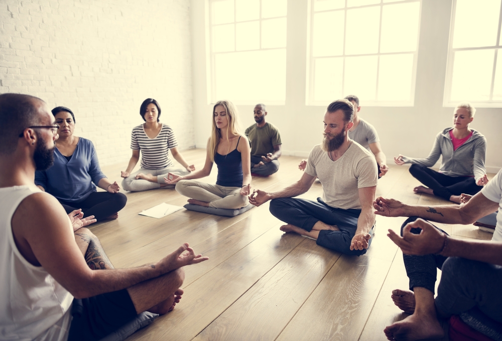 beginner meditation men and women practicing in a group
