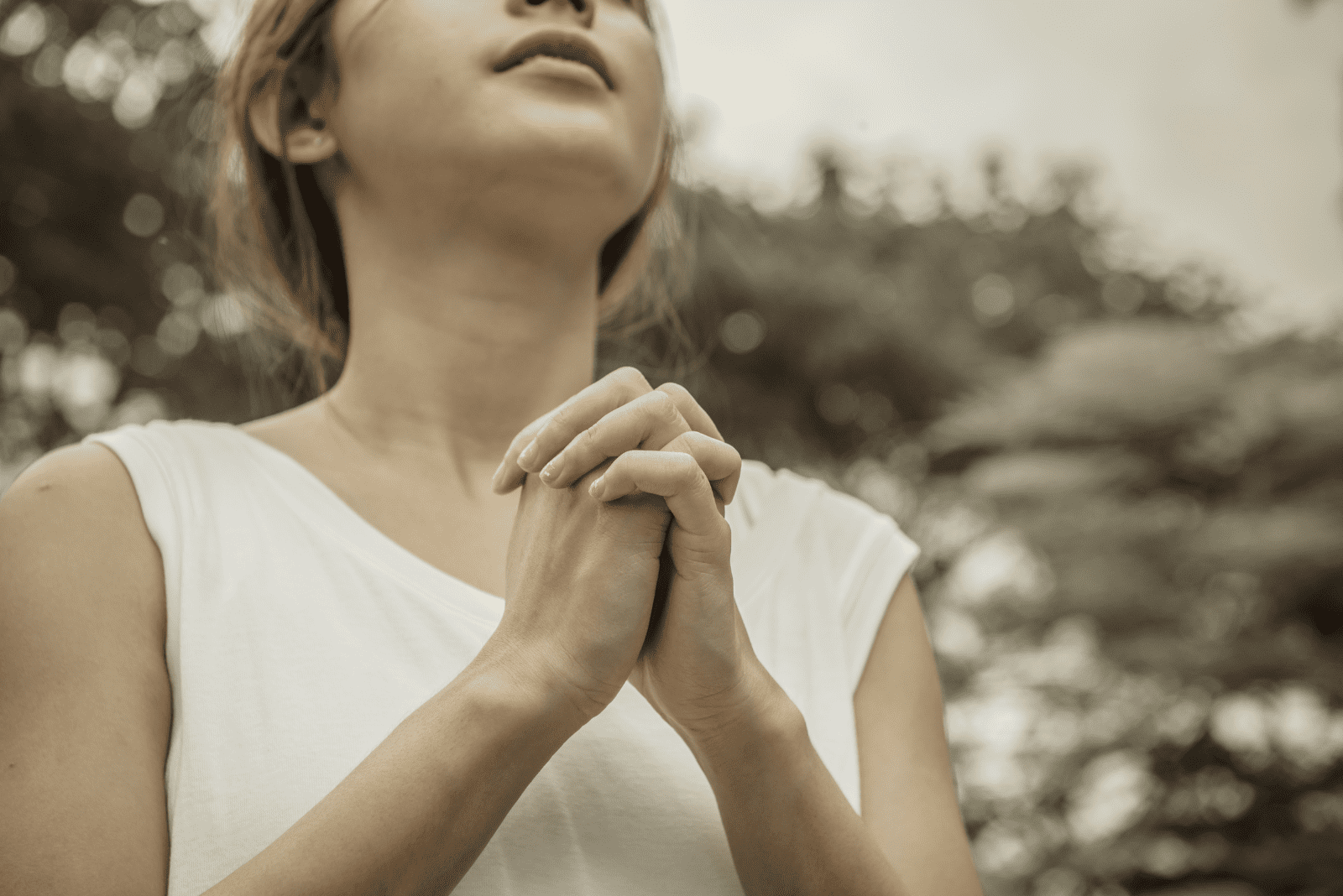 a woman stands up and prays 