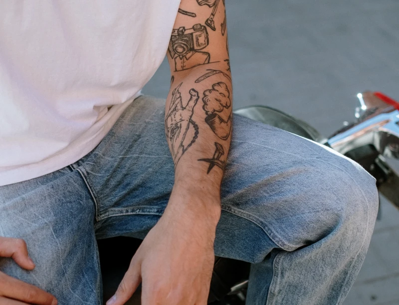 tattoo man arm pattern astrology hand jeans white t shirt