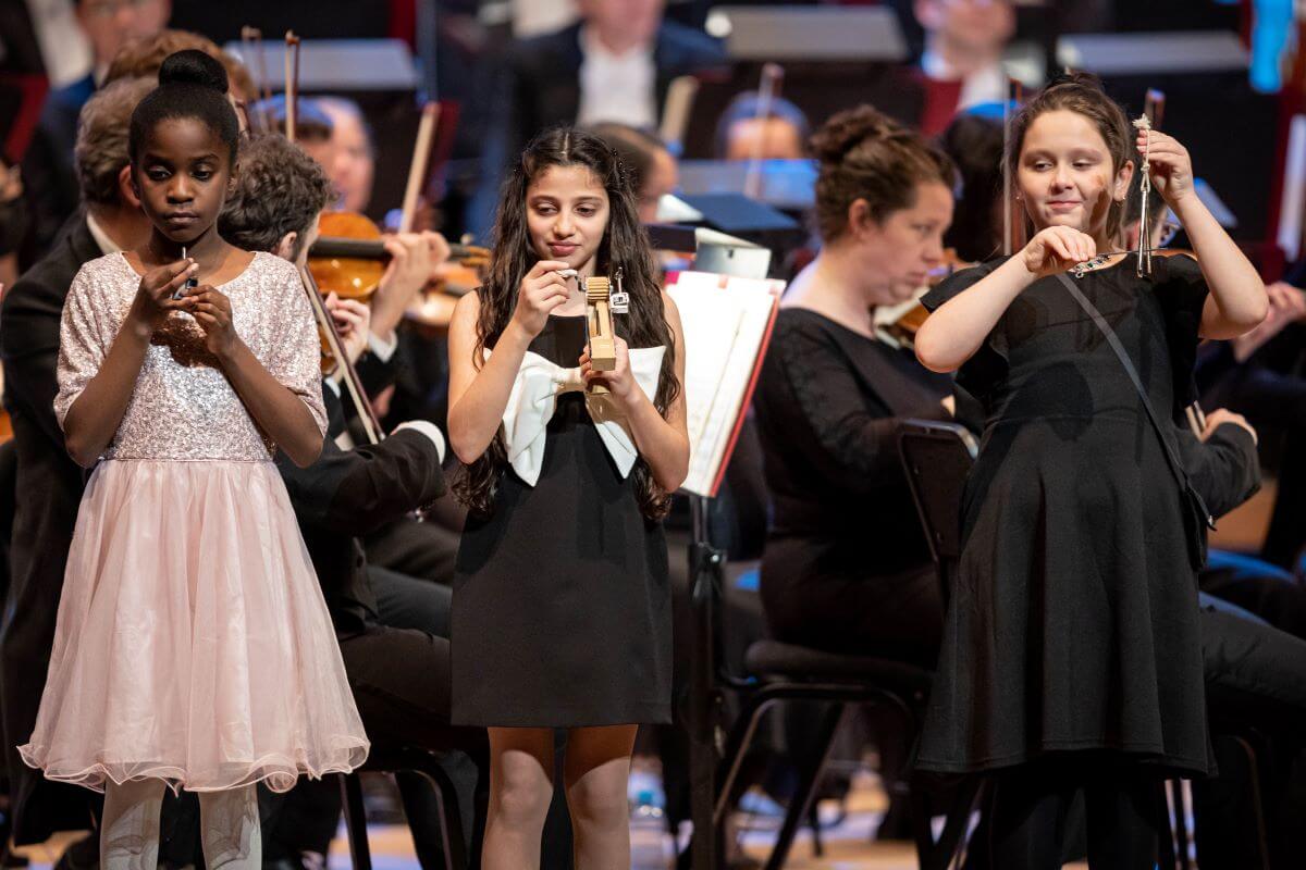 Three young participants of the Music for Children program at the concert "Let's sing Christmas with Rafael Payare" from December 14, 2022. (Photo: Antoine Saito)