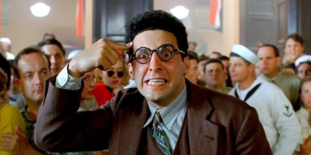 John Turturro as Barton Fink acting in the middle of a crowd in Barton Fink