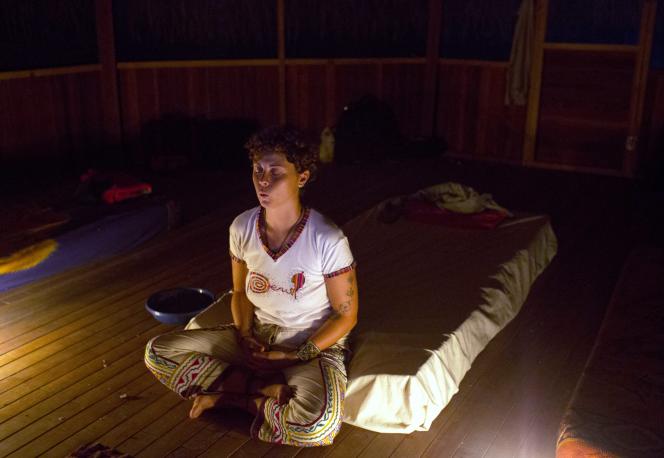 An Italian woman meditates after drinking ayahuasca in Nuevo Egipto, a remote village in Peru's Amazon jungle on May 6, 2018.